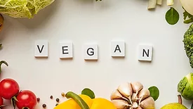 scrabble tiles spelling 'vegan'