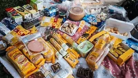 a spread of UPFs on a picnic blanket_Matheus Bertelli via Pexels.png a spread of ultra-processed snacks, meats, and sweets on a picnic blanket outside