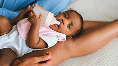 baby holding bottle