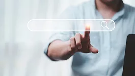 businessperson touching holographic search bar hanging in midair