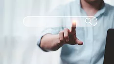 businessperson touching holographic search bar hanging in midair