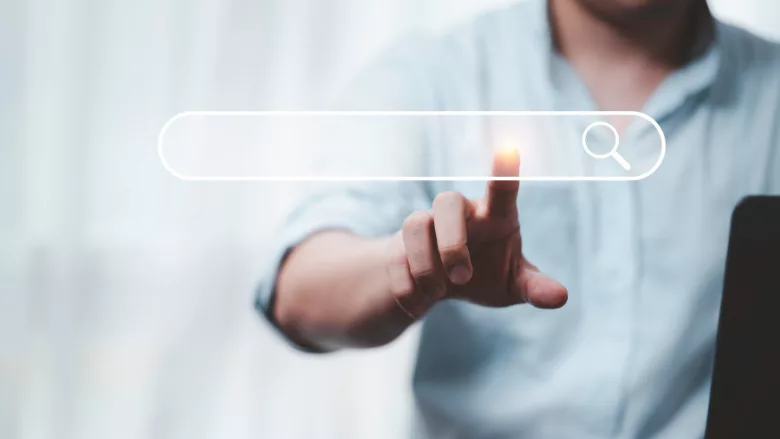 businessperson touching holographic search bar hanging in midair