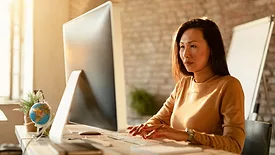 businesswoman using desktop computer at work