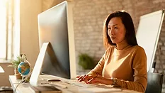 businesswoman using desktop computer at work