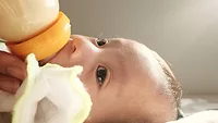 close-up of baby drinking bottle_Trung Nhan Tran via Unsplash.png baby drinking from a bottle