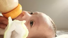 baby drinking from a bottle