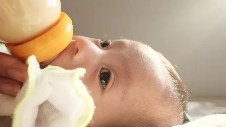 baby drinking from a bottle