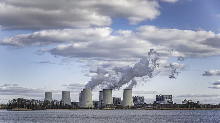 coal power plant emissions next to water body_wirestock via freepik.png coal power plant emissions next to water body