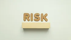 cork letters that say "risk"