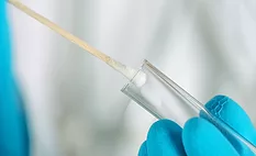 cotton swab going into tube