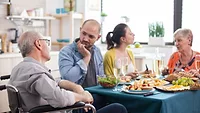 elderly couple eating with family_DC studio via Magnific.png older adult man and woman eating a meal with younger couple