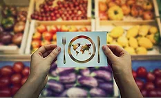 hands holding paper depicting fork knife plate and world map in front of assorted colorful produce_Bulat Silvia iStock Getty Images Plus via Getty Images.jpg hands holding paper depicting fork knife plate and world map in front of assorted colorful produce