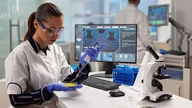 microbiologist in lab working with pipette and petri dish with microbial colony