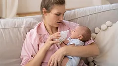 mother giving little baby newborn a bottle_freepik via magnific.png mother giving little baby newborn a bottle