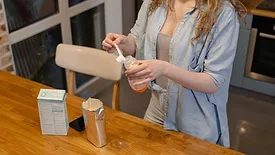 mother preparing bottle of infant formula