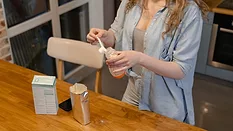 mother preparing bottle of infant formula