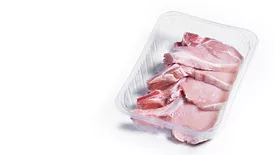 package of raw pork chops on a white background