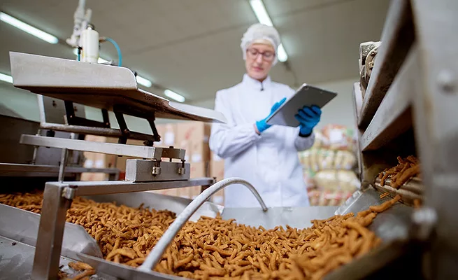 person overseeing production of dry snacks in processing facility