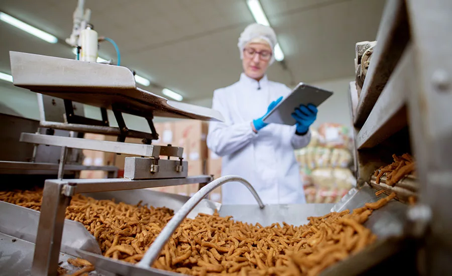 person overseeing production of dry snacks in processing facility