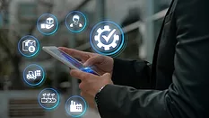 person using tablet with icons representing supply chain