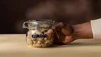 person's hand holding jar labeled 'soy meat'_cottonbro studios via Pexels.png a person's hand holding a jar labeled "soy meat" filled with soy meat product