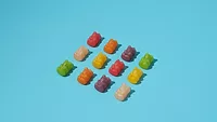 rows of gummy bears blue background_freepik.png rows of gummy bears blue background