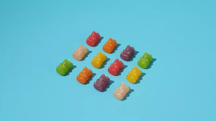 rows of gummy bears blue background