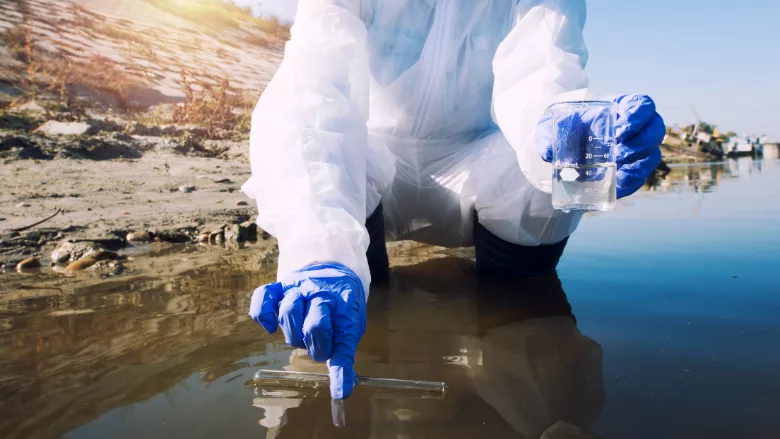scientist collecting environmental water sample