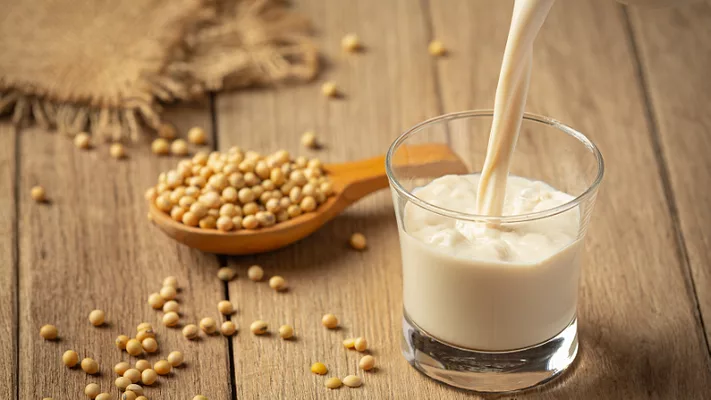 soybeans and soymilk_jcomp via Freepik.png soybeans and a glass of soymilk on a wooden table