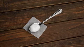 tablespoon of sweetener on wooden table
