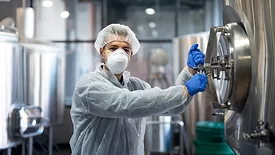 technologist opening processing tank