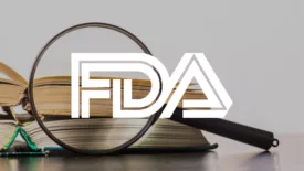 magnifying glass and books with fda logo overlay