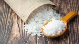 rock salt in burlap sack and wooden spoon