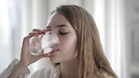 woman drinking a glass of water