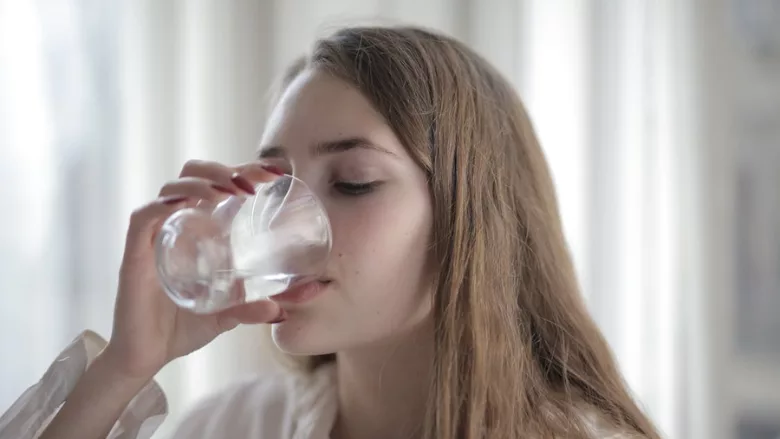 woman drinking a glass of water