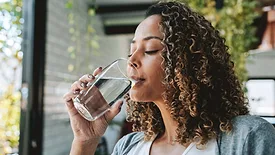 woman drinking a glass of water
