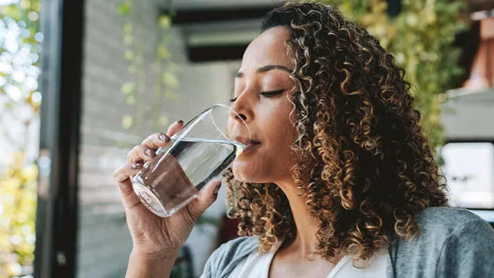 woman drinking a glass of water