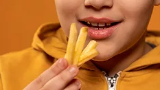 young boy eating fries