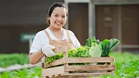 Portrait of asian farmer woman holding wooden box full of fresh raw vegetables_jcomp via Magnific.png Portrait of asian farmer woman holding wooden box full of fresh raw vegetables