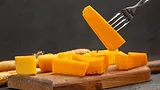 cheddar cheese wedge on a fork