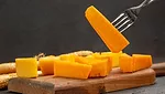 cheddar cheese wedge on a fork