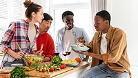 diverse friends eating meal together