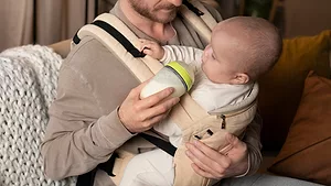 father feeding baby