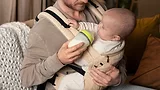 father feeding baby