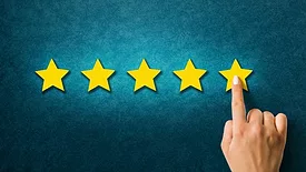 a finger pointing at five stars on blue background