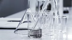 glass beakers with clear liquid chemistry equipment_Hans Reniers via Unsplash.png glass beakers with clear liquid