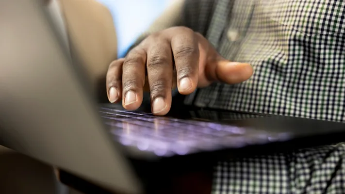 hand typing on laptop