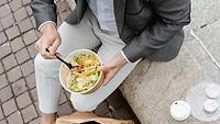 person eating salad out of takeout bowl_MART PRODUCTION via Pexels.png person eating salad out of takeout bowl