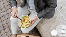 person eating salad out of takeout bowl_MART PRODUCTION via Pexels.png person eating salad out of takeout bowl