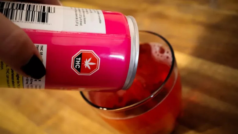 pouring a pink canned thc drink